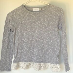 Place long sleeve dressy top with floral base